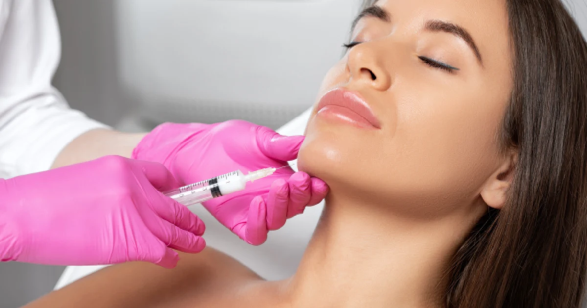 Woman receiving a Kybella injection under the chin in Bellmore, NY
